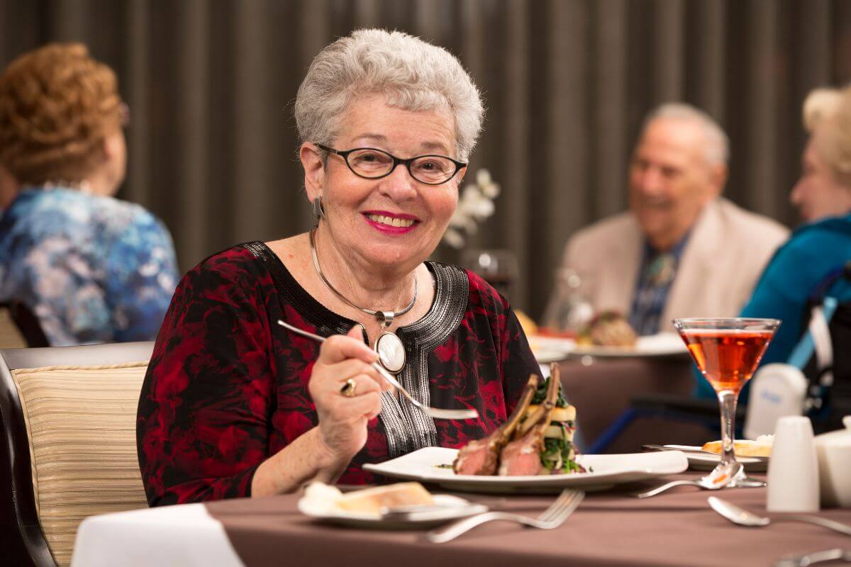 The image of seniors dining at the restaurant and enjoying their meals indicates seniors can enjoy discounts on restaurant meals without worrying about overspending.