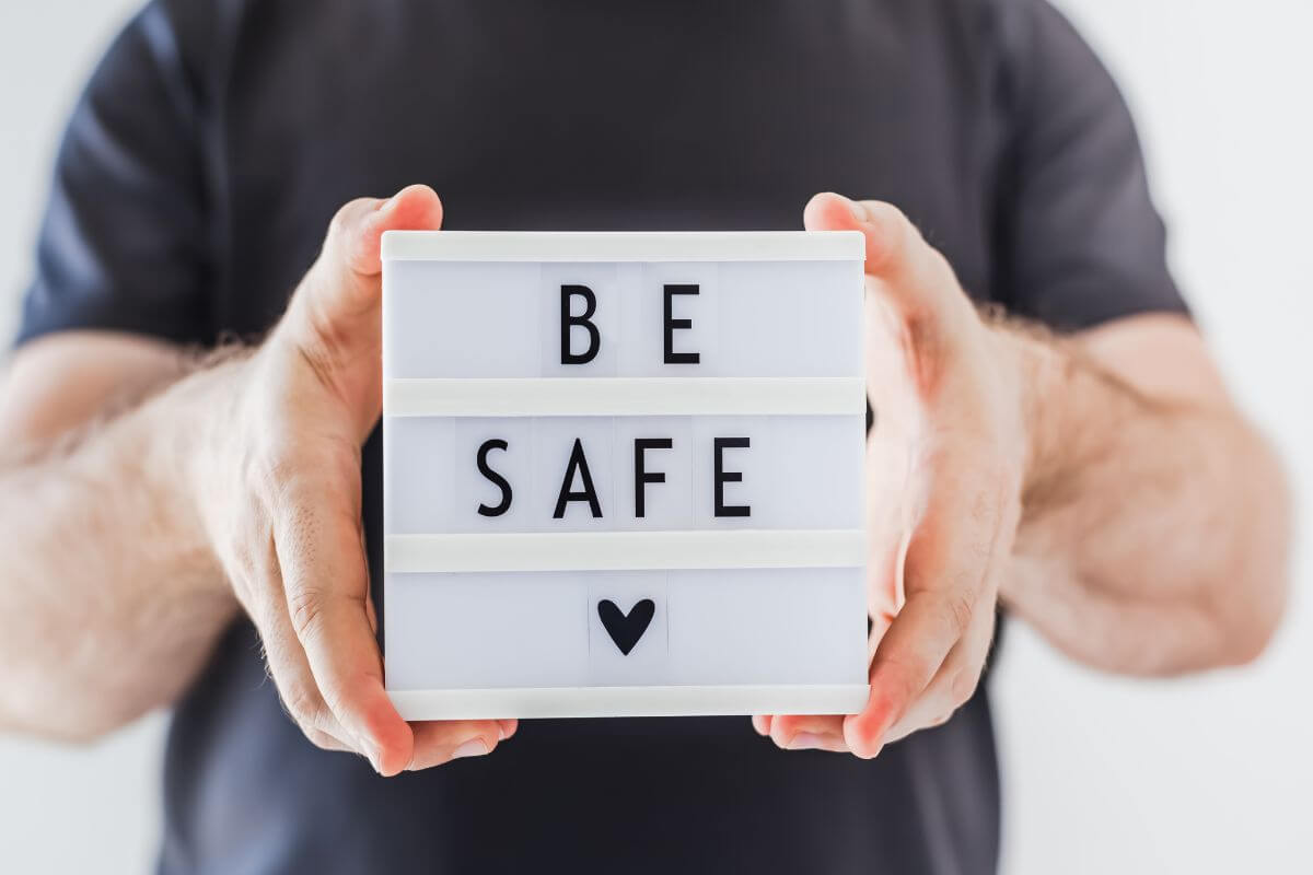 The picture tells about a man's hand holding a white thing with notes indicating to get out safe is the top priority when evacuation orders come is the most important step in emergency situation.