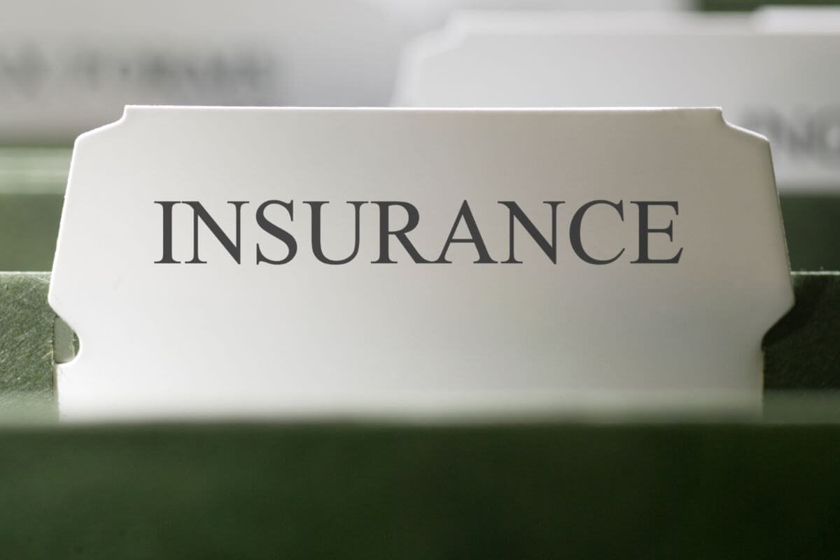 The picture shows a folder with notes, which means organizing financial documents like insurance policies and bank statements in a fireproof folder ahead of time helps reduce chaos when an evacuation order comes.