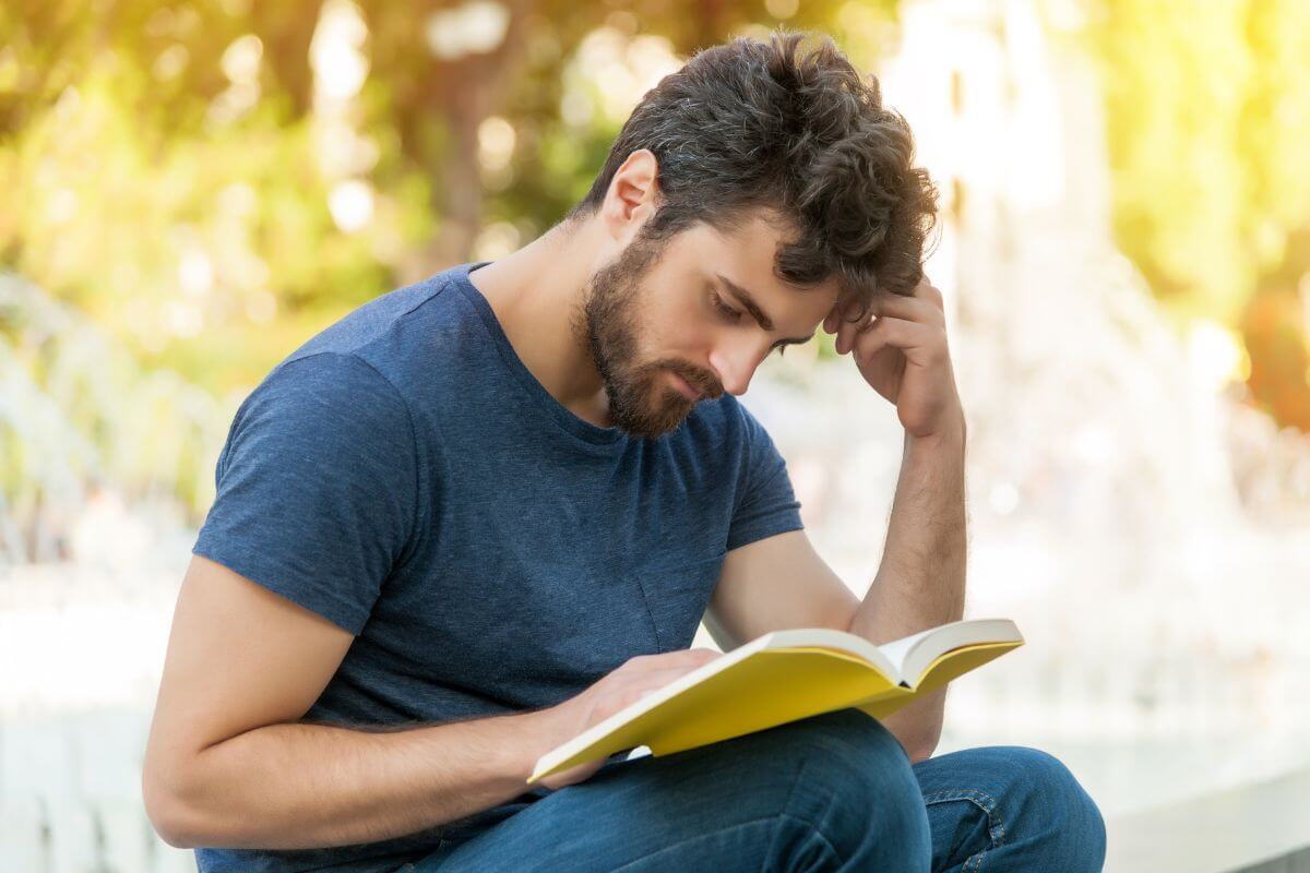 The picture tells about a man sitting while reading a book titled Set for Life by Scott Trench which explains how small lifestyle changes can help you save aggressively and reach your money goals faster.