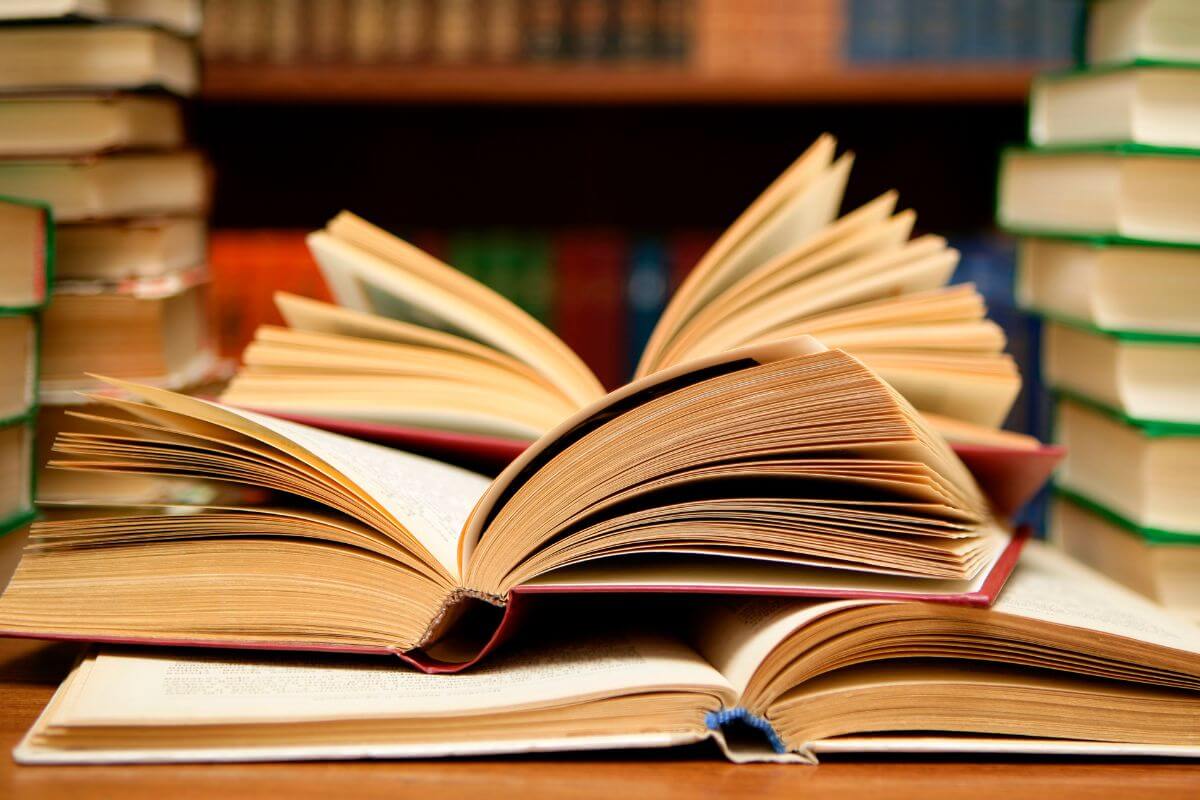 The picture of books on the table indicates to explore more personal finance books to succeed and gives you tools to build a stronger financial future.