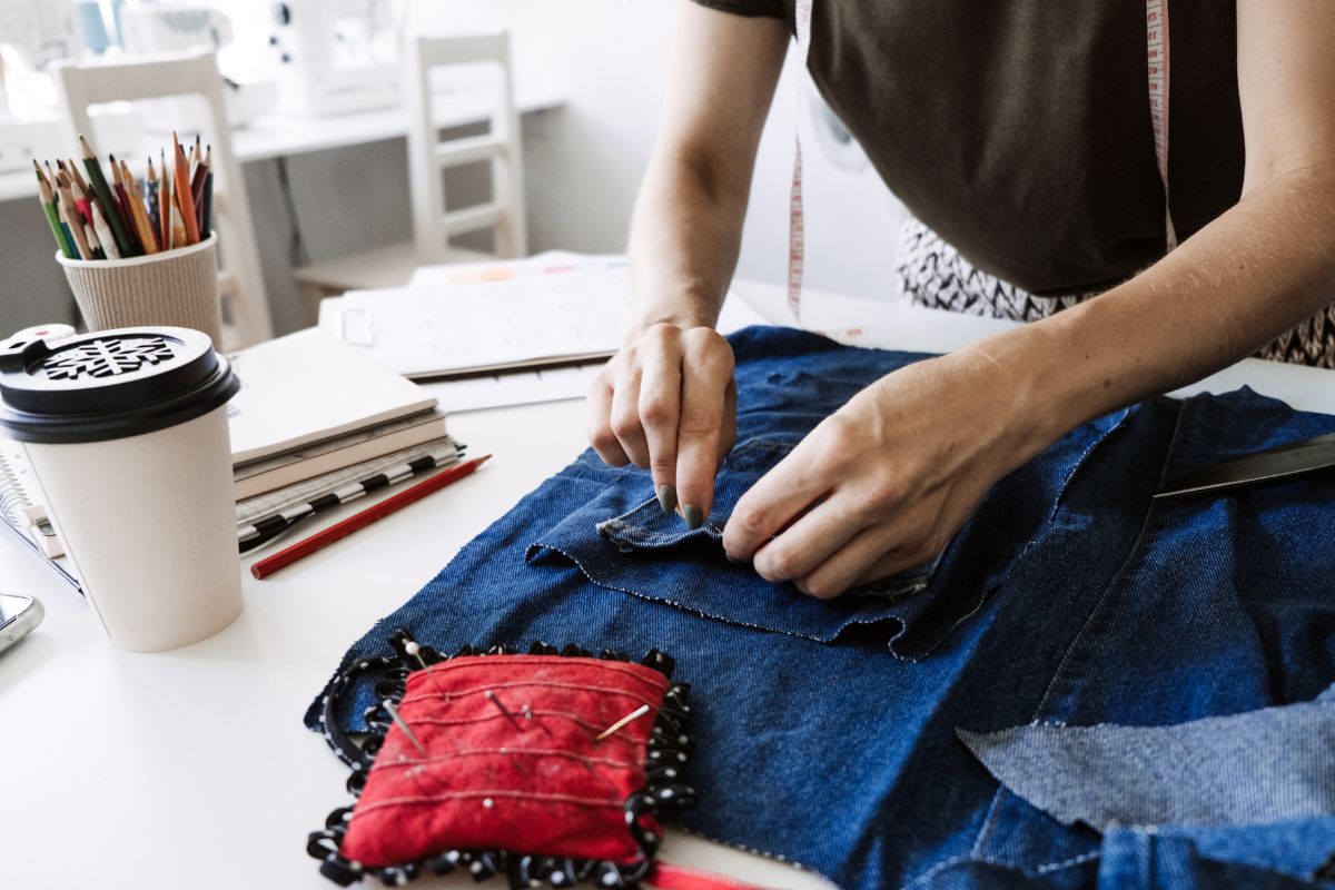 Image of a woman sewing a jean.