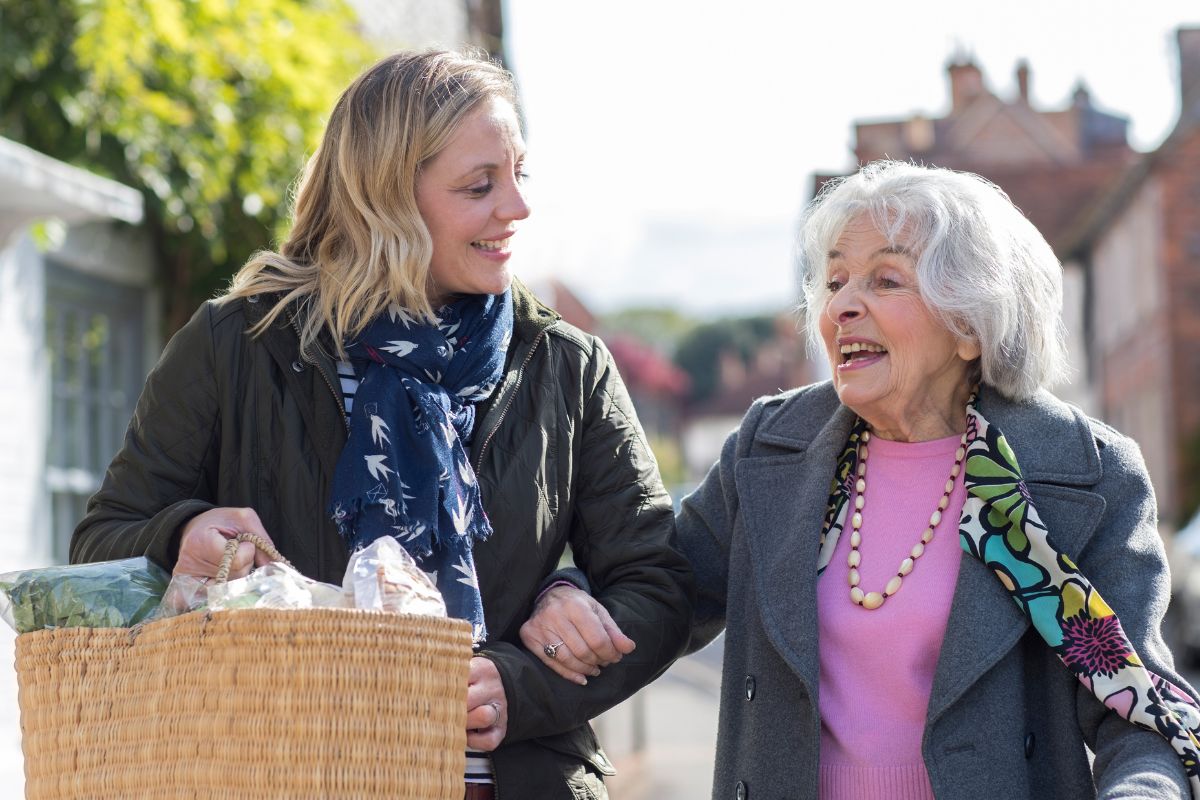A woman helping a senior woman.