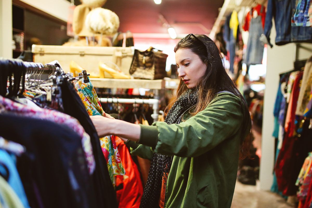 The image shows a woman shopping in a secondhand store.