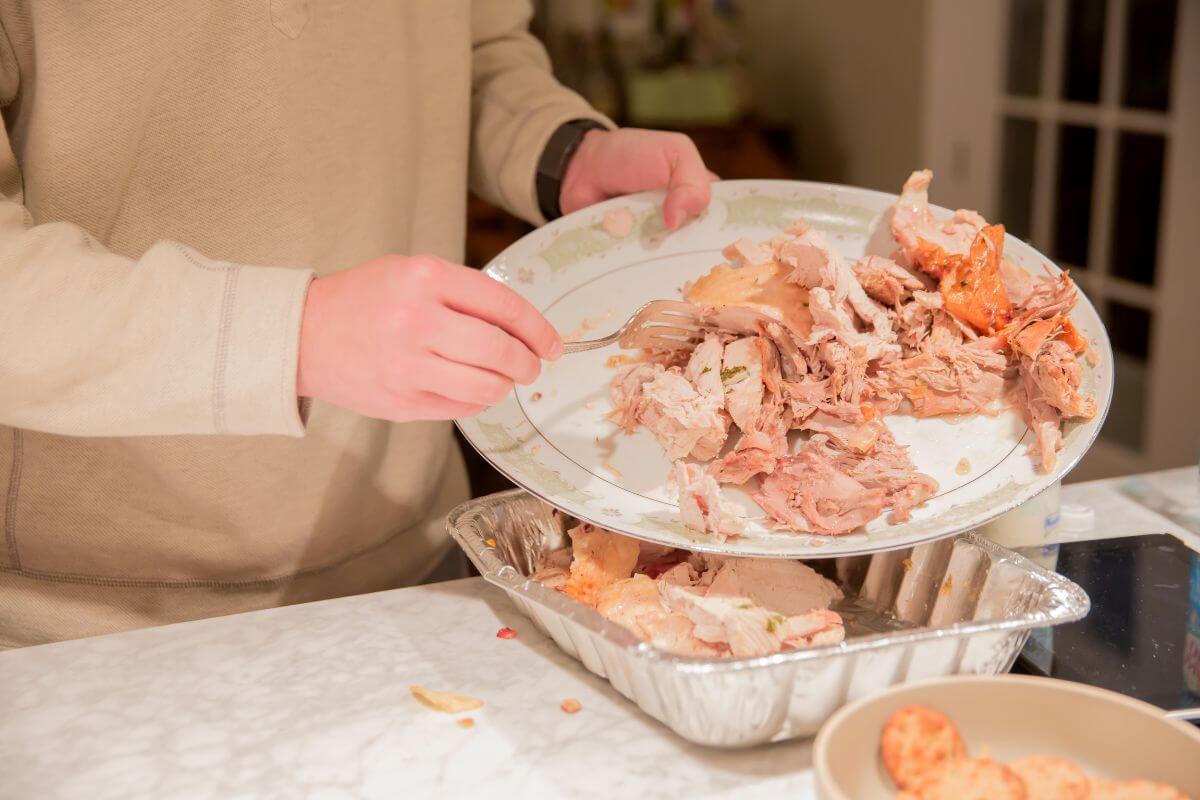 The picture shows containers with food and a girl's hand putting them back which refers to using leftovers creatively to stretch meals and keep your grocery budget in check. 