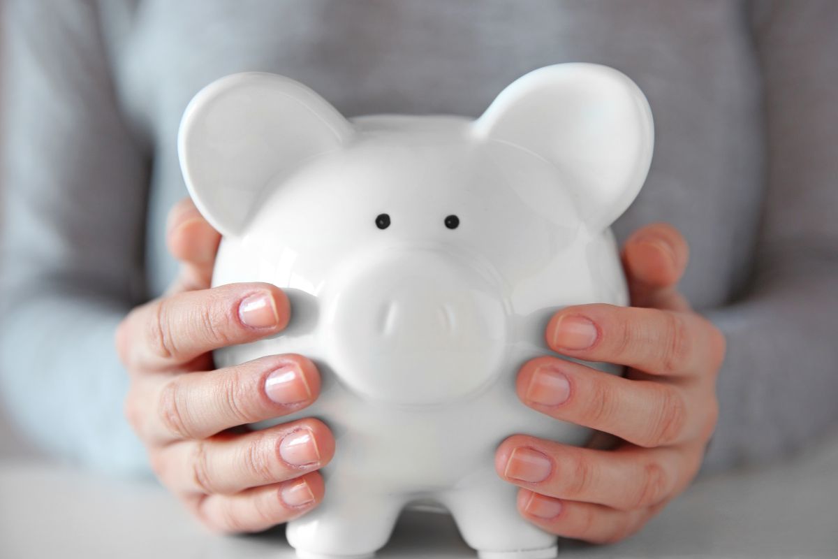  A woman's hand holding a piggy bank.