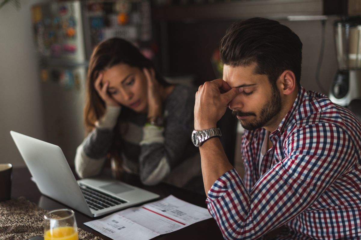 Photo of a couple worried about debt.