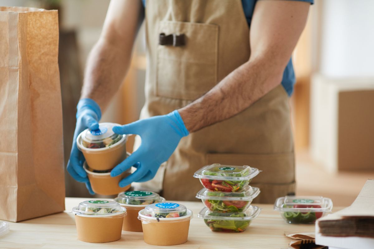 Picture of a man packaging food.