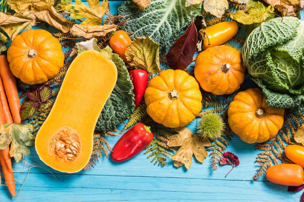 The picture tells about different varieties of vegetables on the table which means out-of-season produce is often overpriced and less fresh, buying season fruits and vegetables options saves money and tastes better.