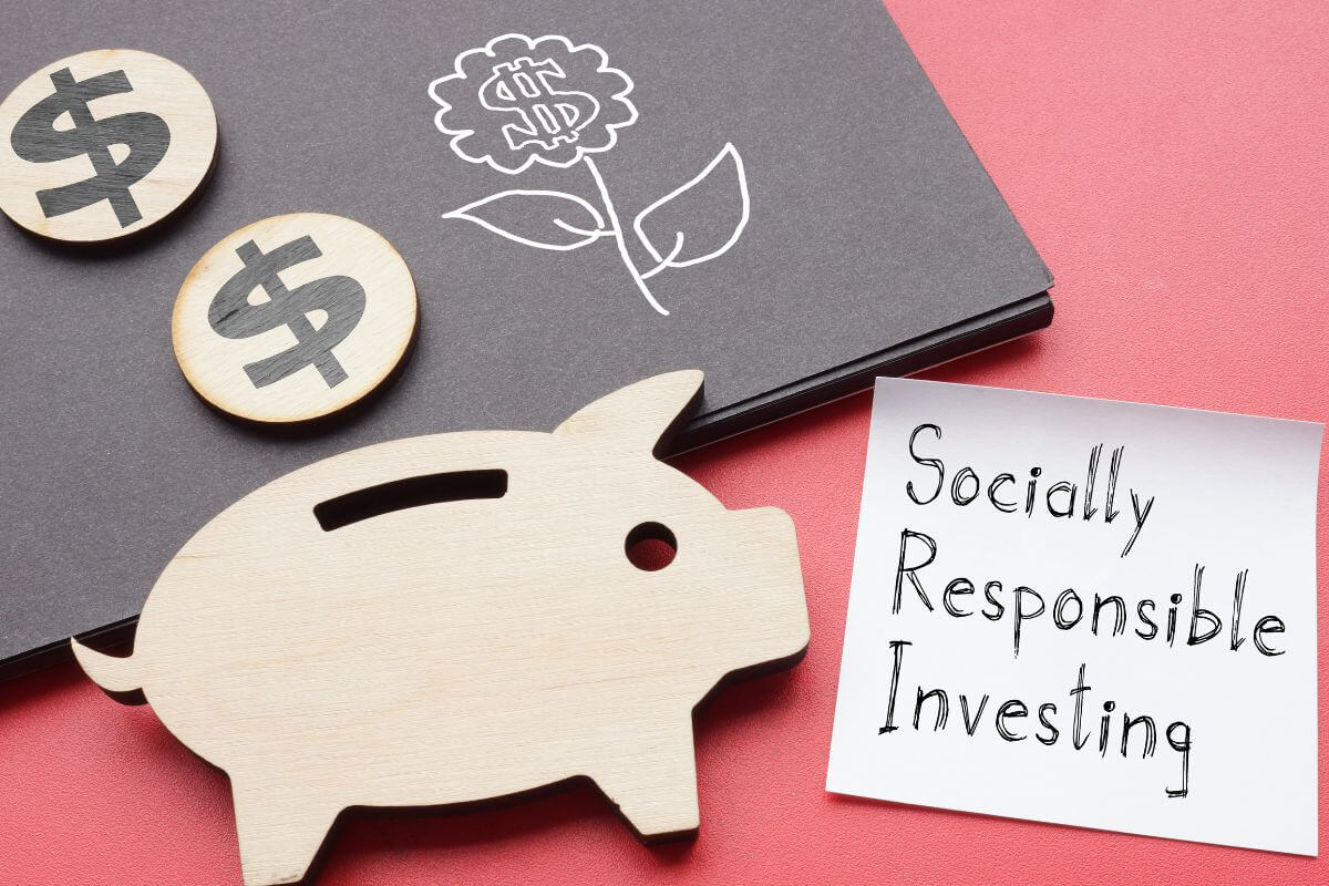 The image tells about black paper, dollar signs on paper, piggy bank paper, and a piece of paper with notes referring to the definition of socially responsible investing.
