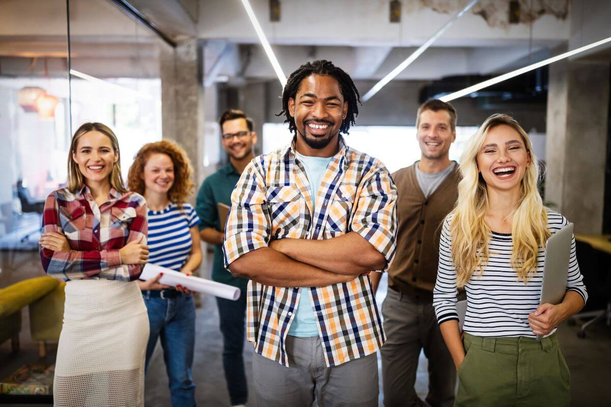 The picture shows happy employees referring to support companies with diverse leadership which makes them a good choice for socially responsible investing.