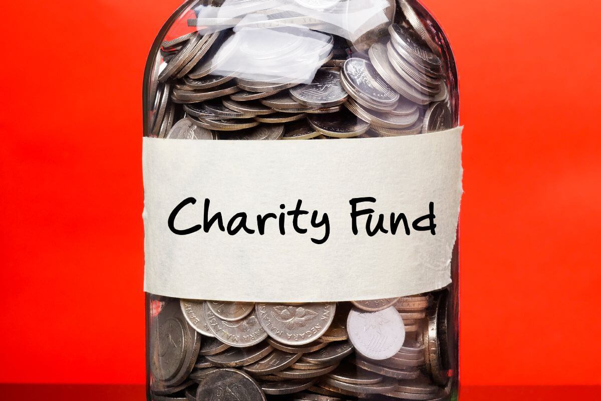 The image shows a jar filled with coins and notes indicating to choose funds that donate to charitable causes which is an excellent way to align your investment with meaningful causes that matter to you.