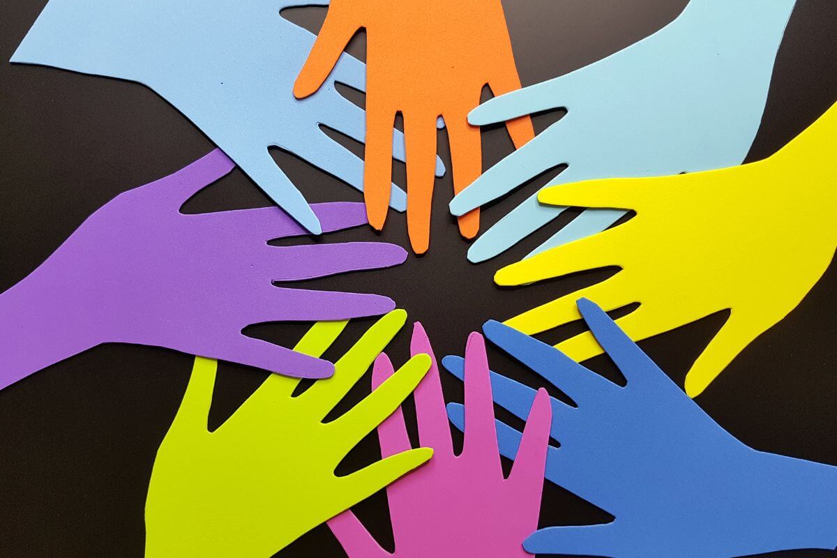 The picture tells about paper hands joining together which means to seek transparency in how companies report their social impact and helps you trust where your money is going.