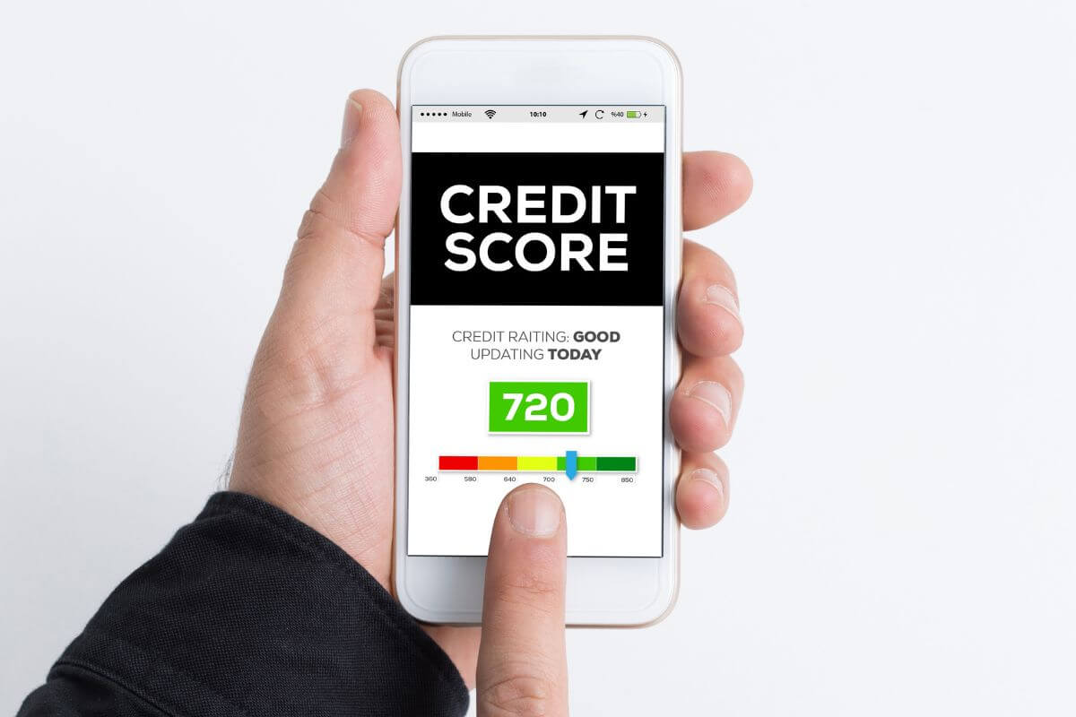 The picture shows a man holding a phone with a screen display, referring to the possibility of building credit without using a credit card with alternatives such as paying loans on time.