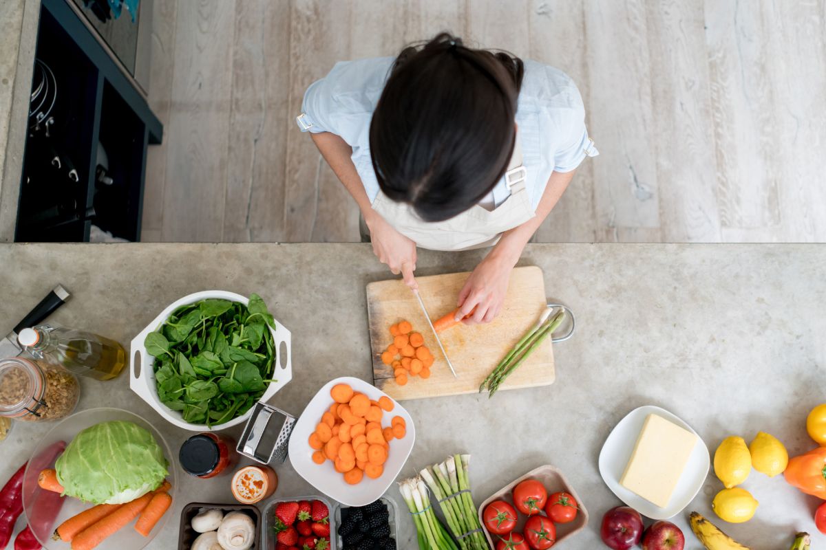 Picture of a woman cooking a meal at home.