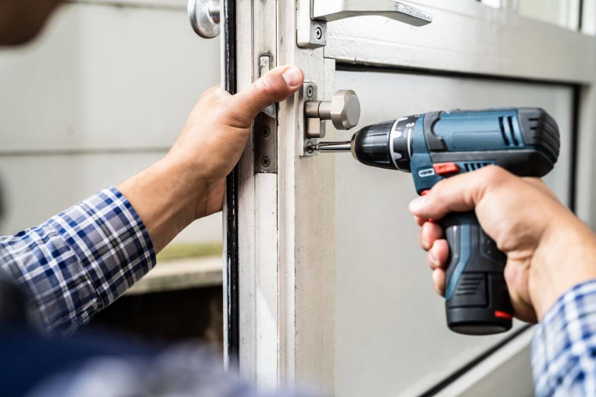 The picture of a man's hand repairing the door lock which refers to repairing and reusing items instead of buying new helps you avoid unnecessary expenses and stretch your budget.