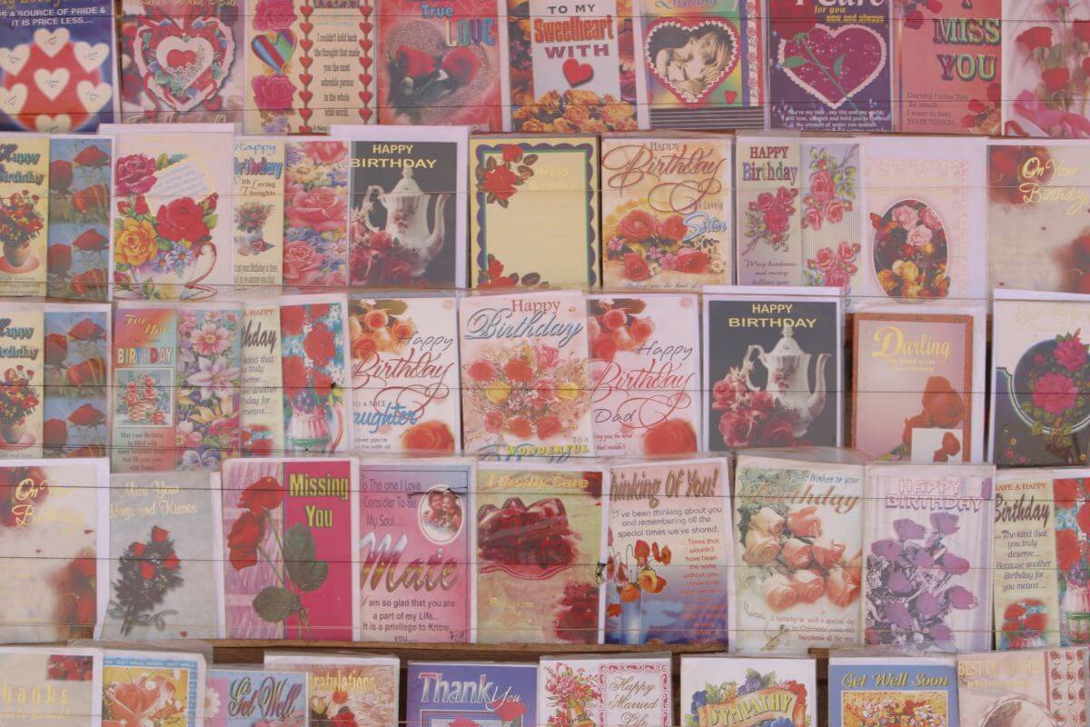 The picture shows different varieties of old greeting cards to clutter, keep only a few meaningful ones, and recycle the rest.