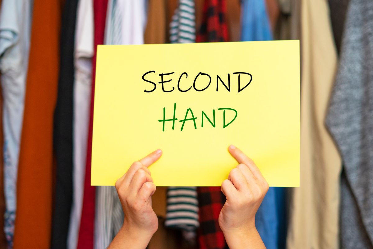 Picture of a woman's hand holding a paper with second-hand wording.