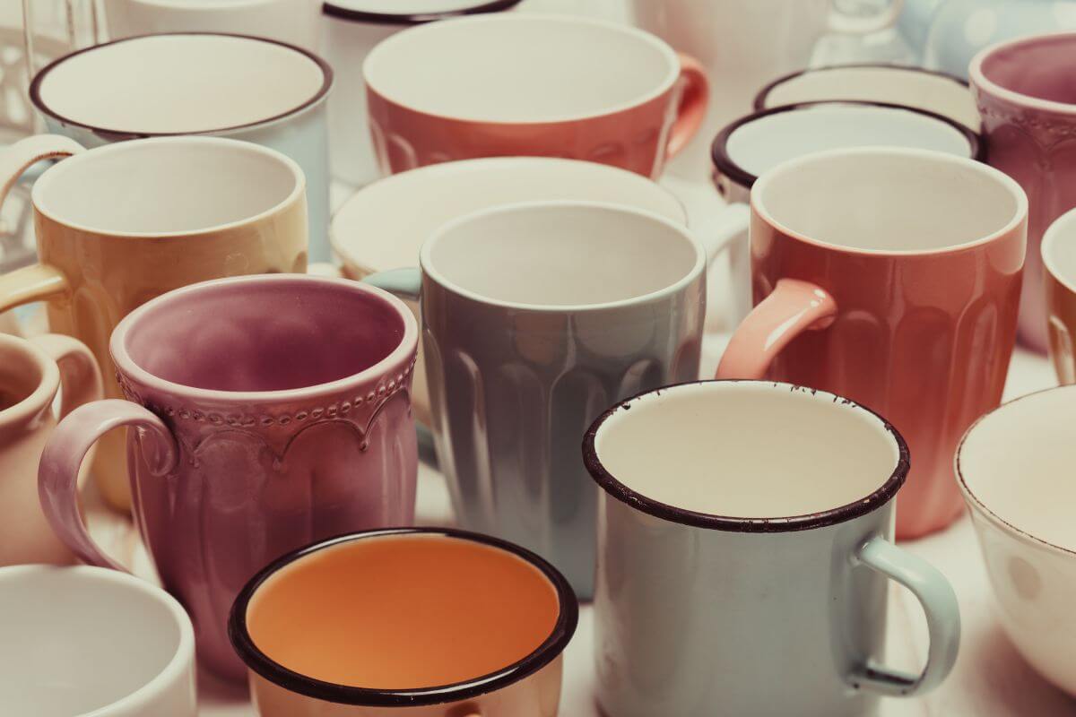 The picture of extra mugs on the table clutter cabinets and makes finding what you need harder, keep a few favorites or donate the rest for an organized and stress-free kitchen.
