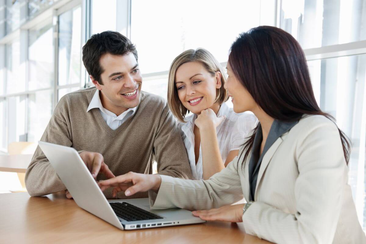 The picture tells about a couple with a financial advisor which means knowing how an advisor is paid or compensated shows if their recommendations are influenced by commissions.