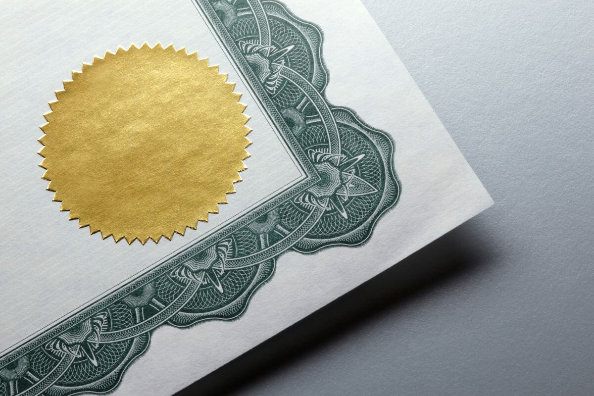 The picture shows a piece of paper with a gold stamp referring to an advisor's certifications showing their training and knowledge in managing finances and helping ensure they have met professional standards.