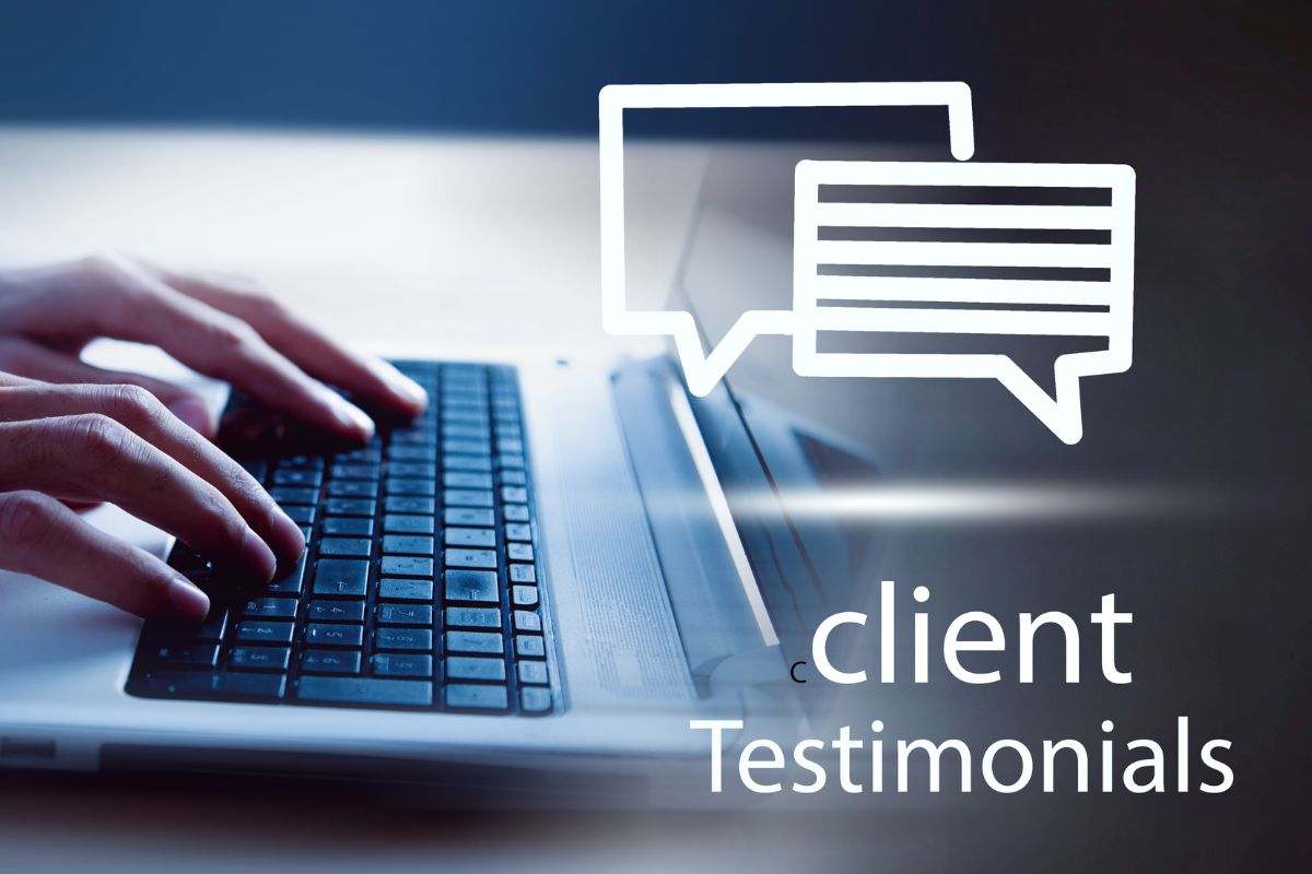 Picture of a man's hand using a laptop for client testimonials. 