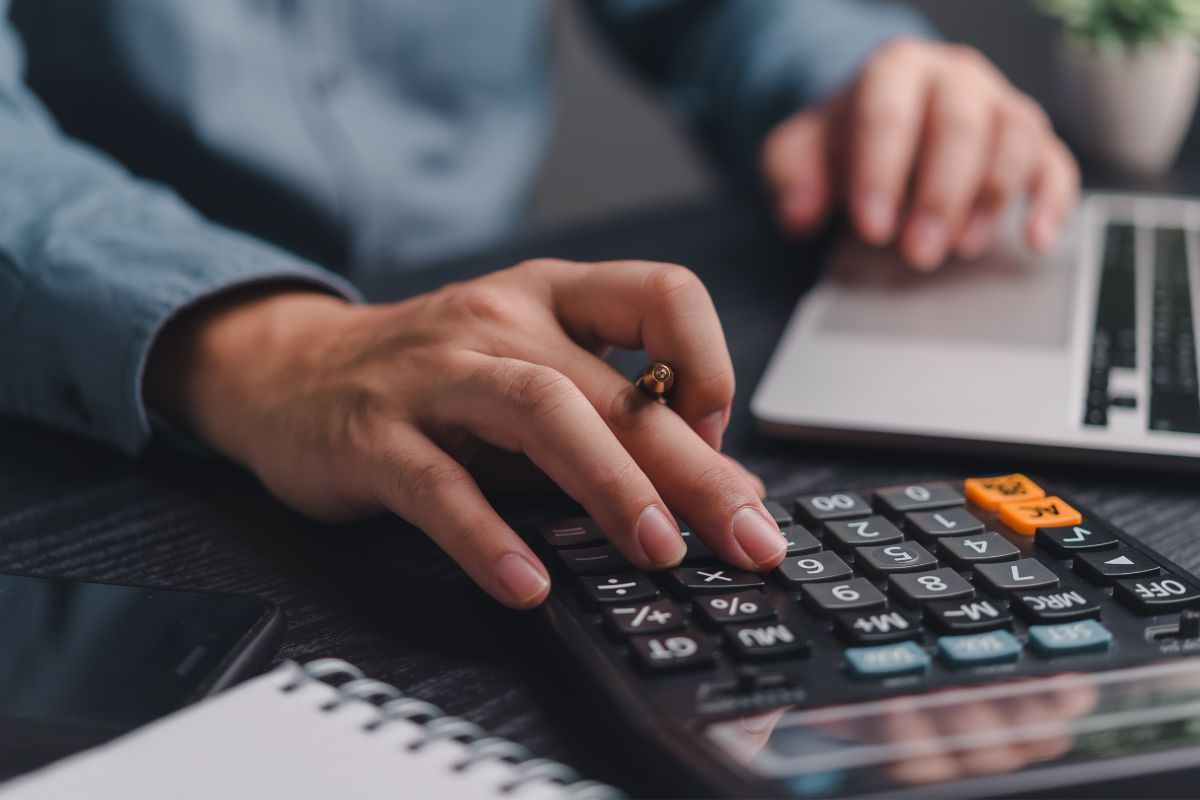 Photo of a man's hand calculating.