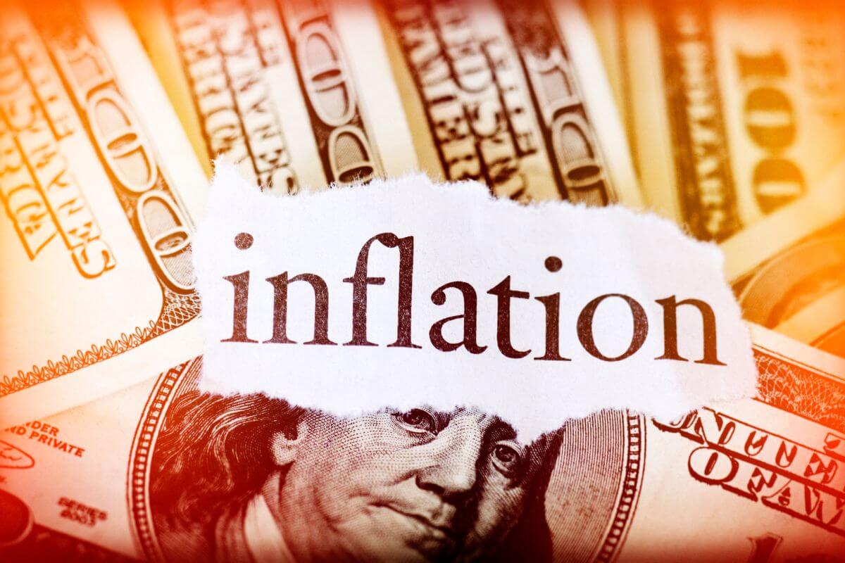 The picture shows dollar bills and a piece of paper with a note indicating the factor inflations into long-term savings goals to ensure your savings retain their purchasing power.