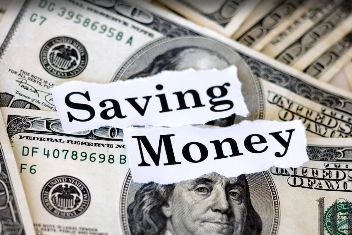 The photo of dollar bills with papers and notes refers to starting savings with these money savings challenges that can lead to big financial changes over time.