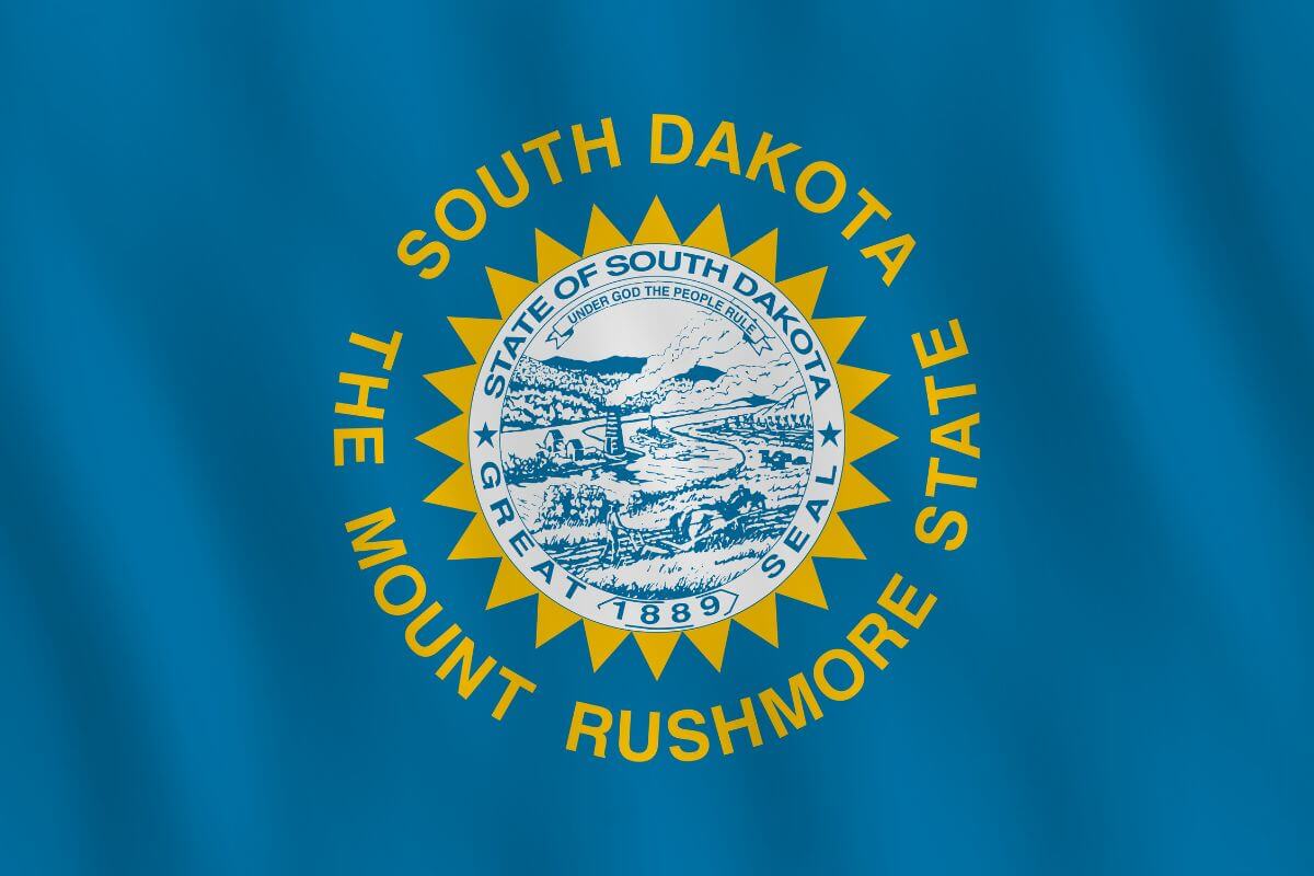 The picture of a South Dakota state flag indicating is one of the most tax-friendly states for retirees with no state income tax.. 