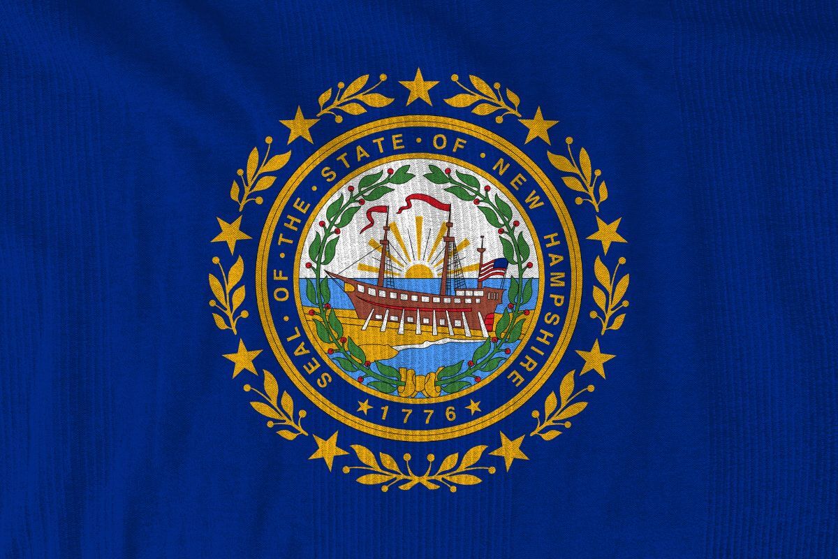 The photo shows a New Hampshire state flag indicating the ideal for retirees who want to save money on taxes and an excellent place to preserve their wealth.