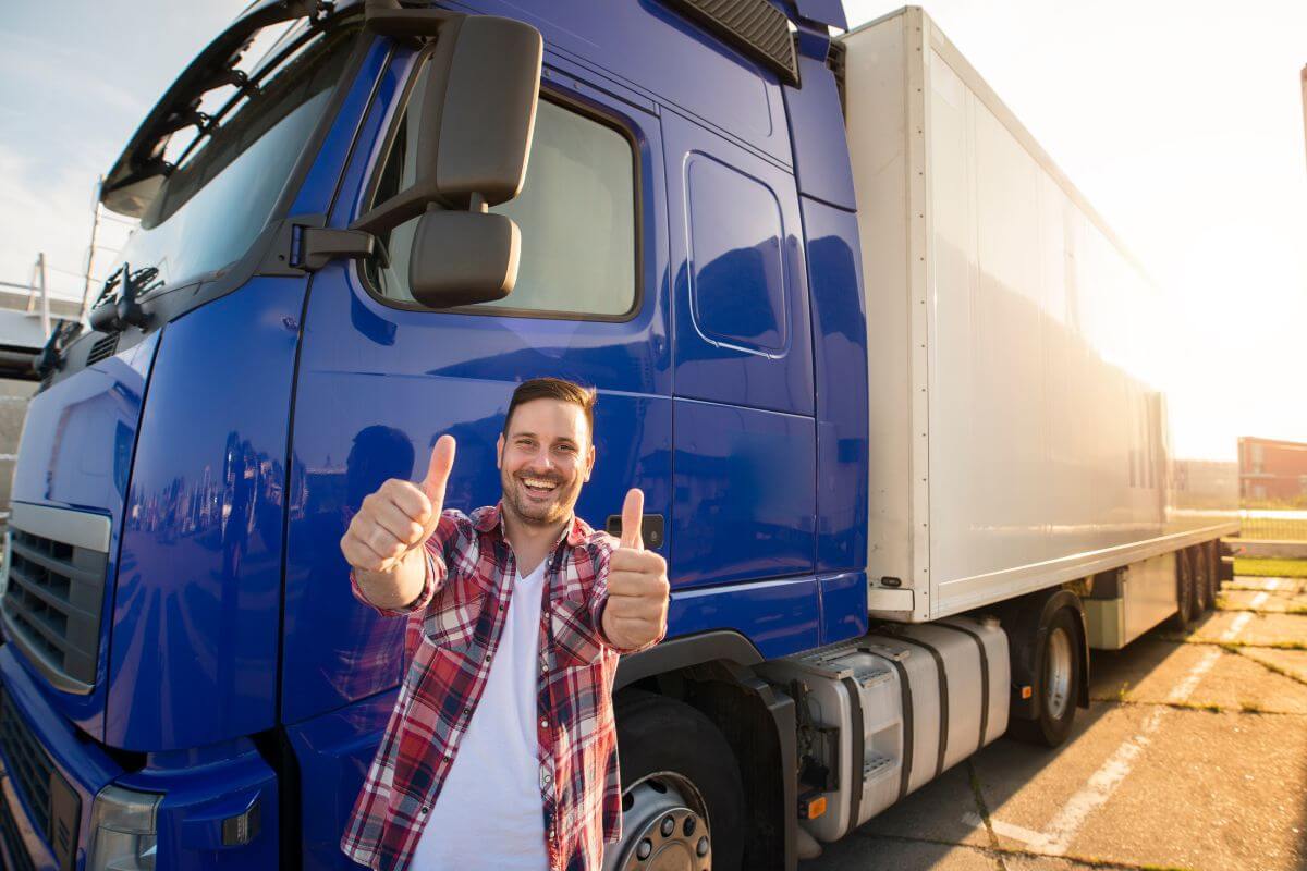 The picture of a truck and a man making an ok sign means truck drivers can earn $50 an hour by transporting goods safely and on time.