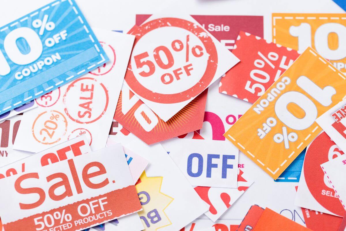 The picture shows different kinds of expired coupons to declutter which only take up space and serve no purpose.