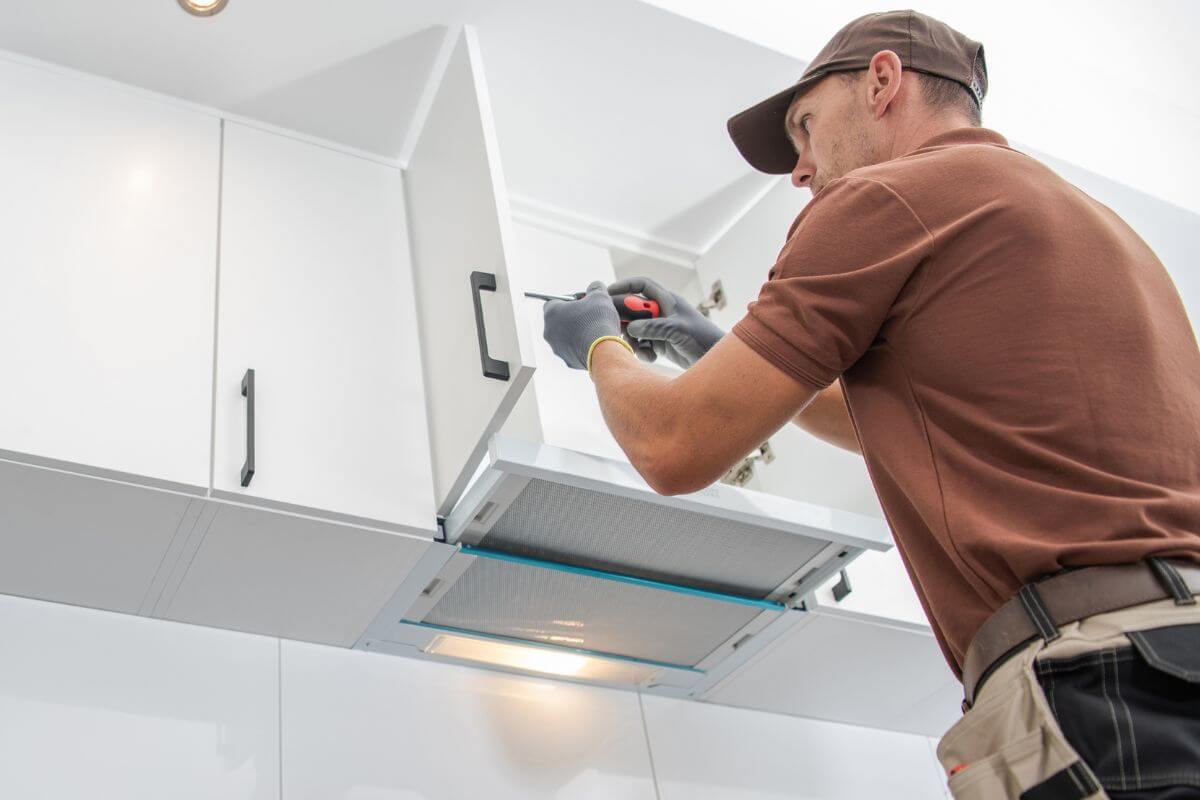 The picture tells about a handyman fixing the cabinet door which means they earn $50 an hour by solving problems and completing home repairs.
