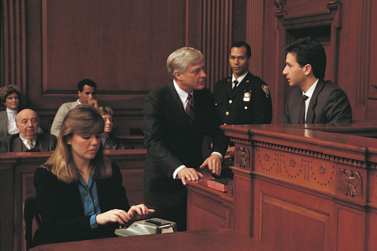 The photo of the audience, police, lawyers, and a court reporter girl using a device indicating that they earn $50 an hour transcribing legal proceedings is a great way to build a high-paying career.