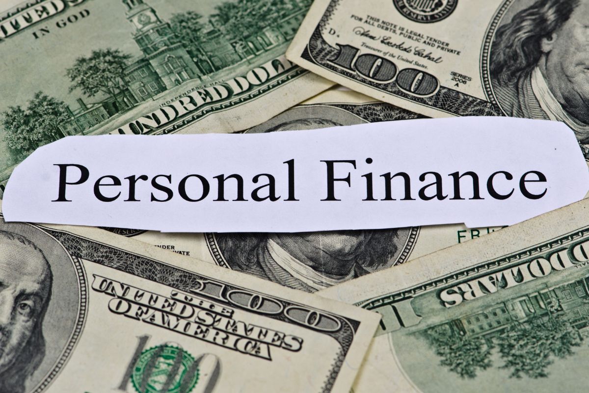 Image of money and paper with personal finance wording.