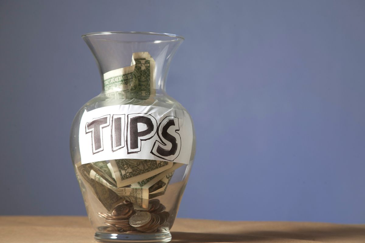The image shows a jar of money tips.