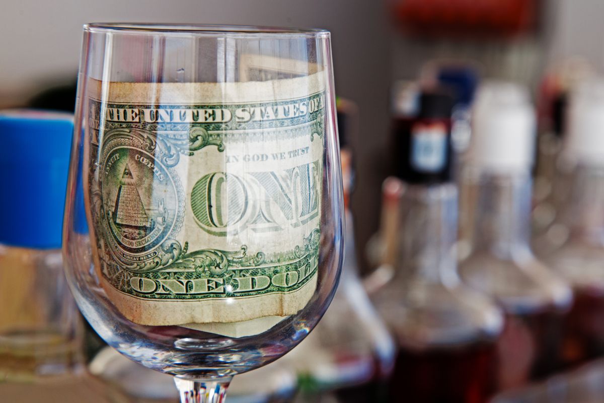Photo of money in a glass drink.