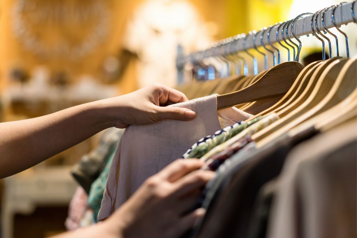 Image shows a woman shopping for clothes.