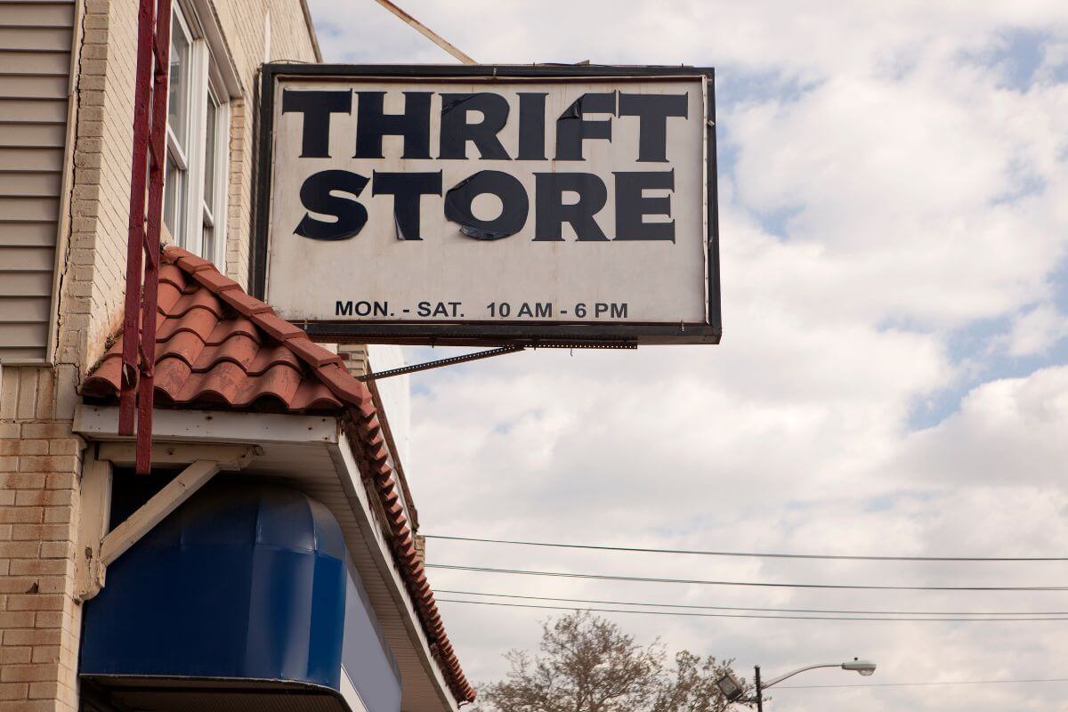 The photo shows a sign that refers to visiting a thrift store at the end of the month to find an abundance of new donations.