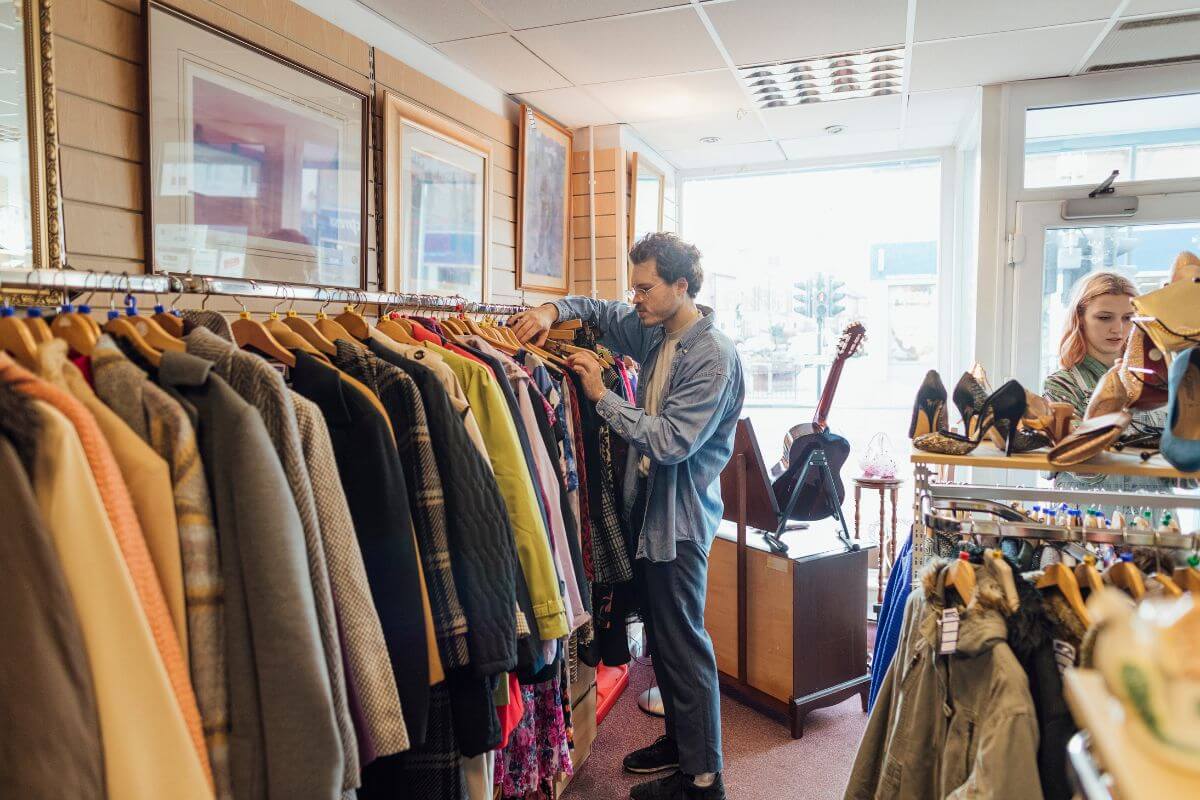 The picture of customers picking items in the thrift store means focusing on versatile and timeless pieces to ensure you get long-term value from your purchases.