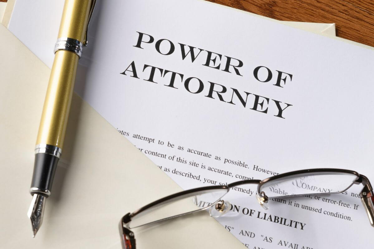 The picture shows a pen, an eyeglass, and a piece of paper with notes referring to creating a durable power of attorney to ensure that someone you trust can make financial and legal decisions for you if you become incapacitated.