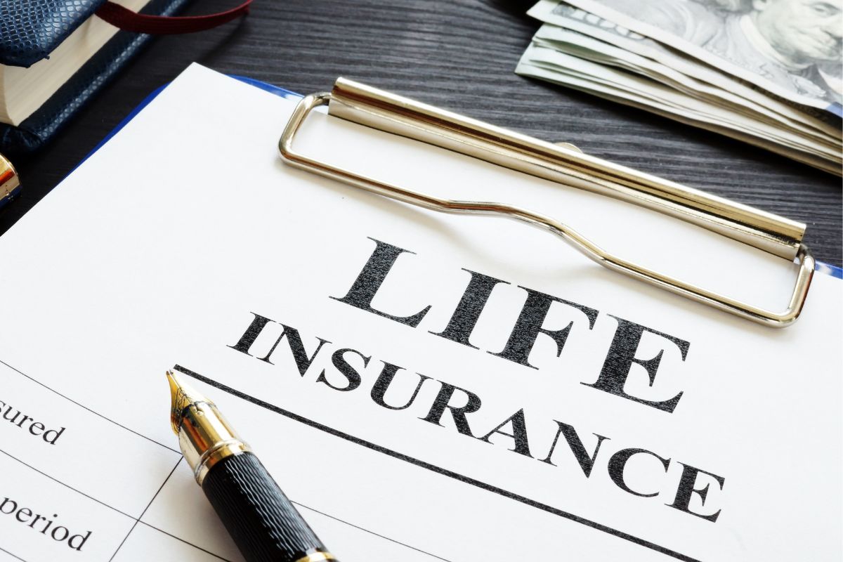 Image of money and paper with life insurance wording.