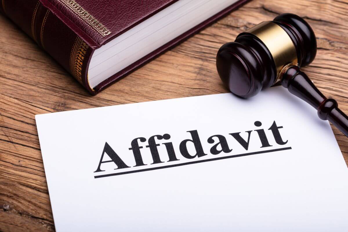 The image shows a book, a gavel, and a piece of paper with a note referring to the use of small estate affidavits for qualifying properties that allow certain assets to pass directly to beneficiaries without the need to probate.