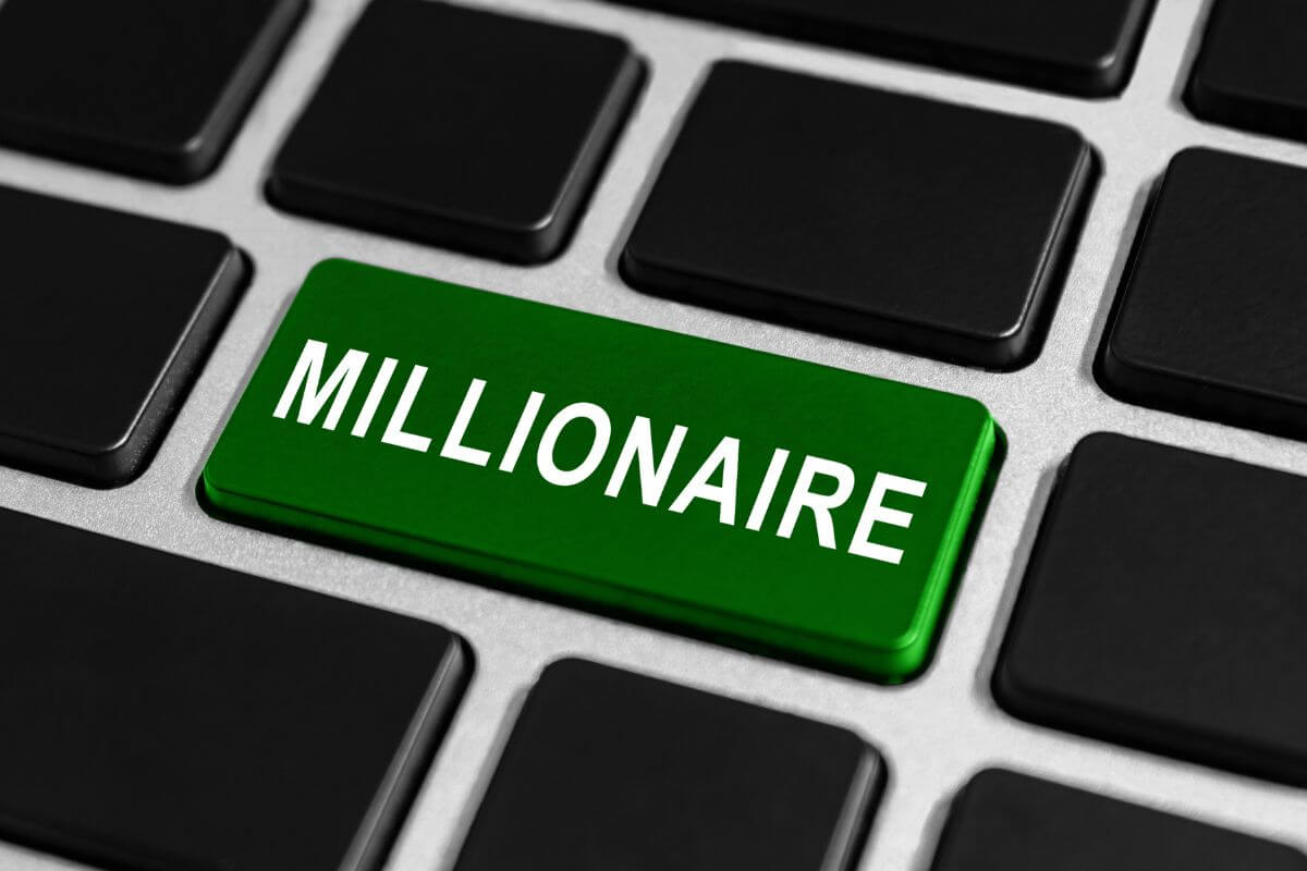 The image tells about a keyboard with a green button and a note referring to learning how to become the next millionaire with no money by building smart habits and taking advantage of free resources.