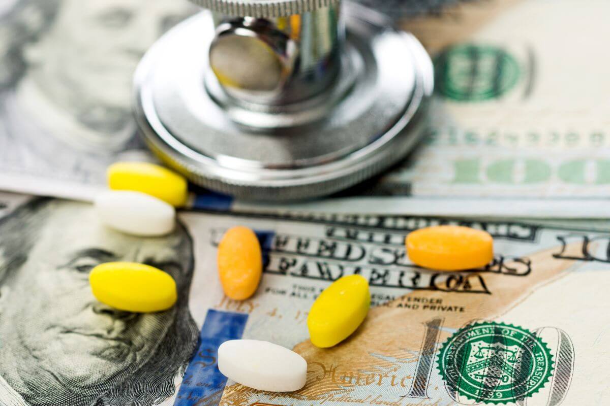 The photo tells about dollar bills, medicines, and a stethoscope which means saving for healthcare costs reduces stress and ensures better care.