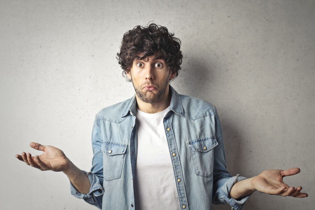 The picture shows a man holding dollar bills indicating that starting your path to be financially independent can lead to long-term financial freedom.