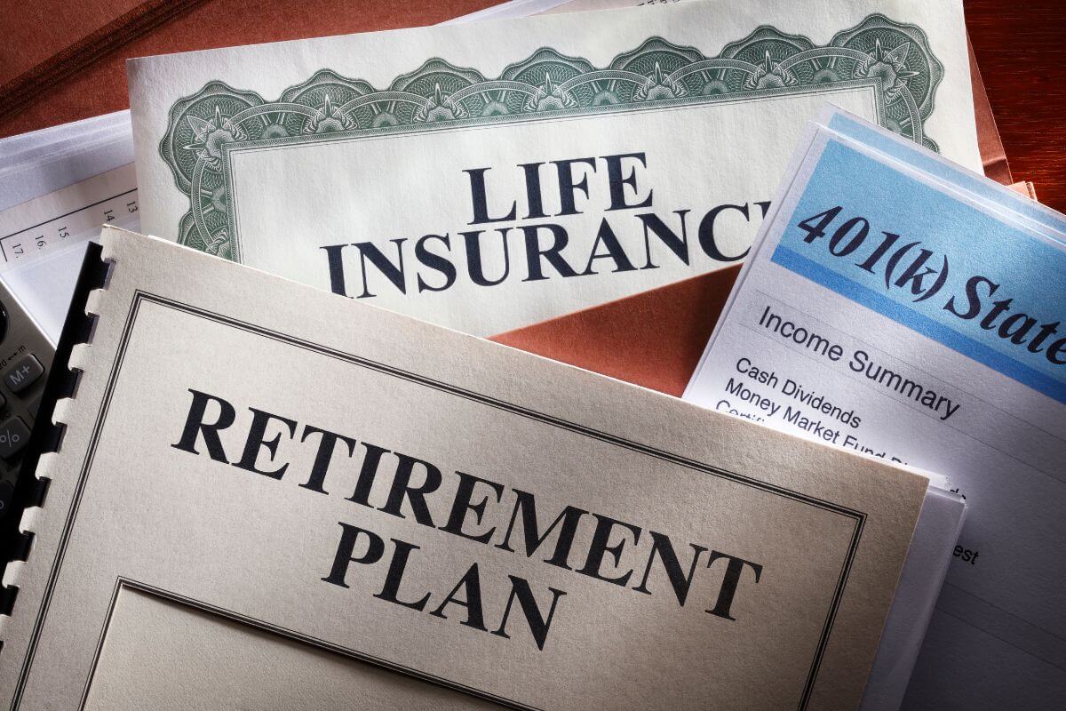 The image tells about papers with notes and a book bound with notes referring to designated beneficiaries for retirement accounts and insurance policies that can be overlooked when planning a will.