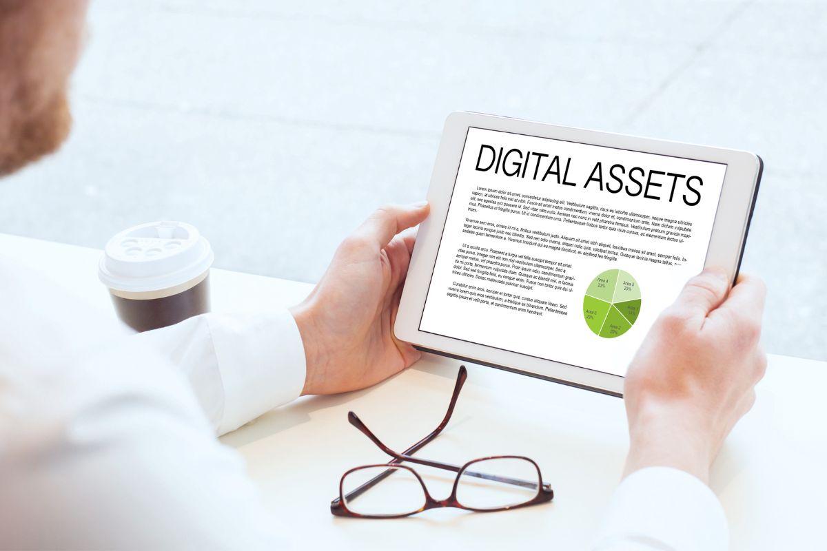 The image of a man's hand reviewing his digital assets.