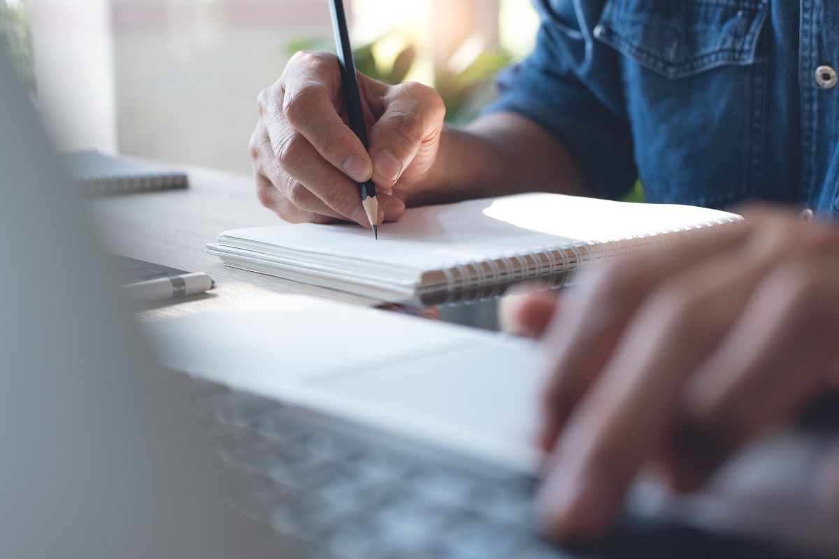 Photo of a man's hand learning online.